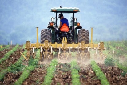 farmer on tractor using fertiliser